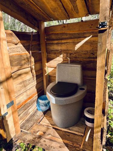a toilet sitting inside of a wooden structure at Oriküla Forest Gottage with Sauna 