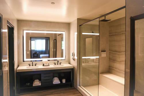 a bathroom with a sink and a shower at The Hotel at Black Oak Casino Resort in Tuolumne