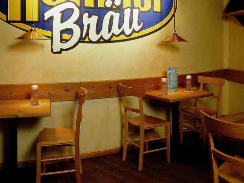 a fast food restaurant with wooden tables and chairs at Mercure Hotel Riesa Dresden Elbland in Riesa