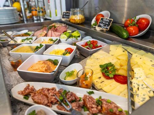 a buffet line with many different types of food at Mercure Hotel Riesa Dresden Elbland in Riesa