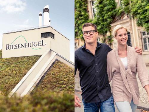 a man and a woman standing in front of a sign at Mercure Hotel Riesa Dresden Elbland in Riesa