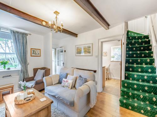 a living room with a couch and a christmas tree at Holme House Cottage in Oakworth