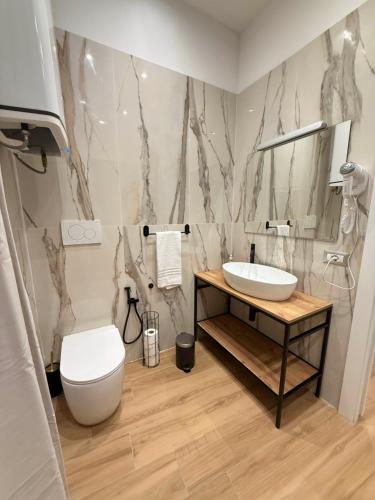 a bathroom with a sink and a toilet at NAVONA MORGAN suite in Rome