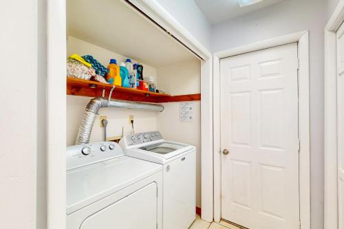a small laundry room with a washer and dryer at Sunkist & Salty in Ocean Pines