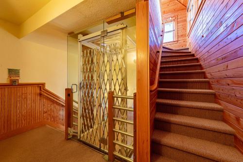 a staircase in a house with a glass door at Sea Shellter in Whalebone