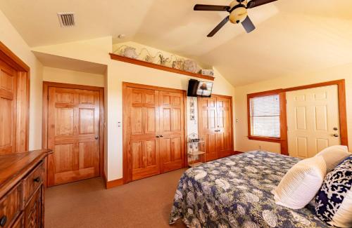a bedroom with a bed and a ceiling fan at Sea Shellter in Whalebone