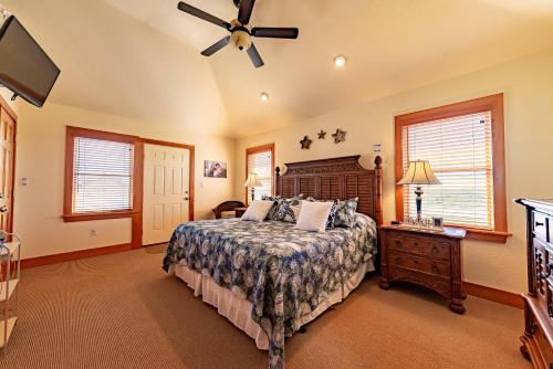 a bedroom with a bed and a ceiling fan at Sea Shellter in Whalebone
