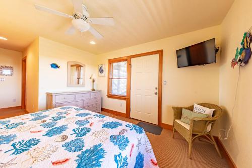 a bedroom with a bed and a flat screen tv at Sea Shellter in Whalebone