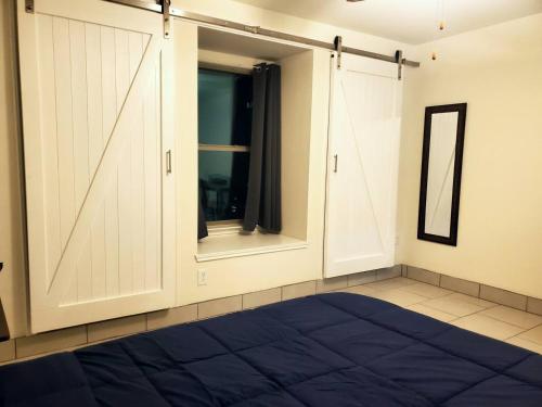 a room with a closet with a large blue bed at Lovely Room 1 Near San Marcosatx in Kyle