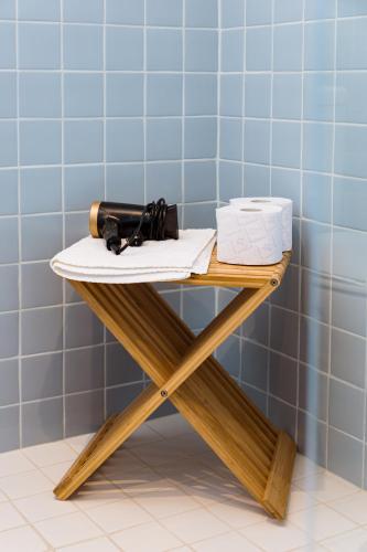 a table in a bathroom with a bottle and a box at Azurara Guesthouse in Azurara