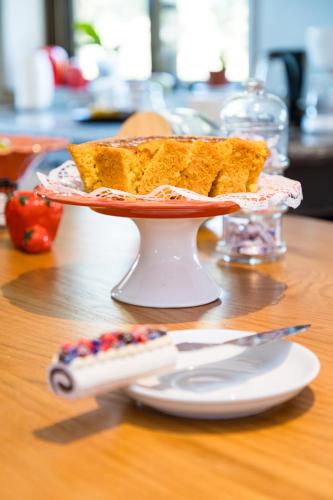 a plate with a piece of cake on a table at Azurara Guesthouse in Azurara