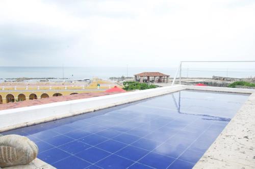 a pool on top of a building with the ocean in the background at Penthouse Caribbean View and private pool, Cartagena in Cartagena de Indias