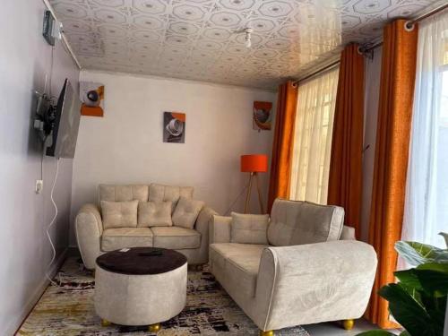 a living room with a couch and a table at Serene suites in Nyahururu