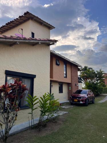 a house with a car parked in front of it at Casa Panaca Portal 12 in Quimbaya