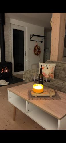 a table with a bottle of wine and a candle on it at Chatka in Roztiezi in Roztěž