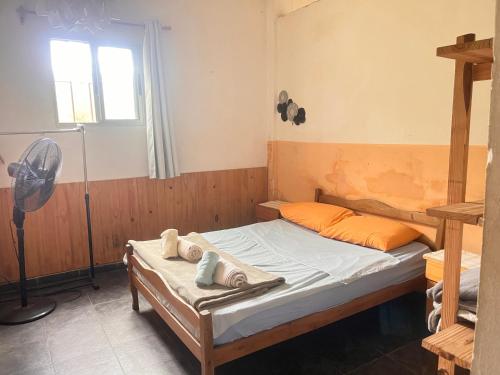 a bedroom with a bed with towels on it at Casa en el campo in Montevideo