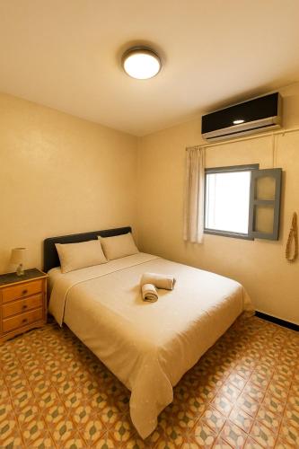 a bedroom with a large bed and a window at Entire Surf & Beach Guest House in Taghazout in Taghazout