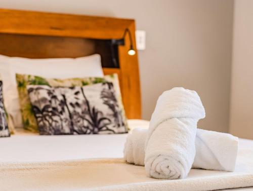 a roll of white towels on a bed at Tranquil Haven Getaway in Dickies Island