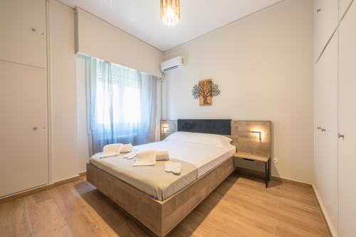 a bedroom with a large bed and a window at Eudoxus Haus in Athens