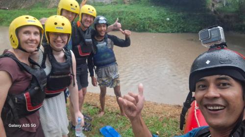 a group of people posing for a picture near a river at SAHATI HOMESTAY PAYAKUMBUH & Swimingpool in Payakumbuh