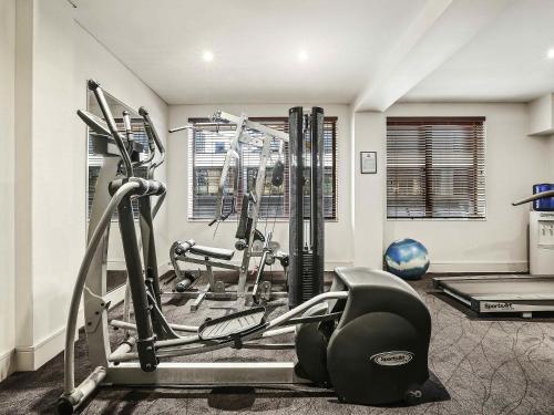 a fitness room with a gym with tread machines at ibis Sydney World Square in Sydney