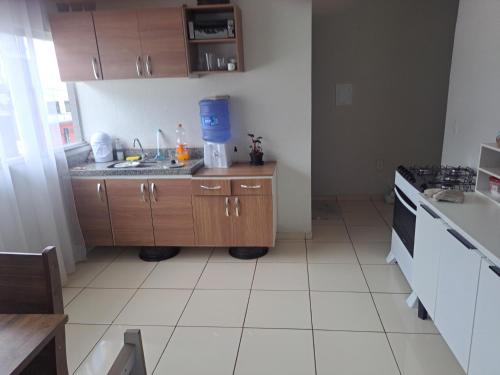 a kitchen with a sink and a counter top at Quarto confortável com armário smart tv e ventilador in Montes Claros
