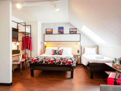 a bedroom with a bed in a room with a staircase at ibis Cherbourg La Glacerie in Cherbourg en Cotentin