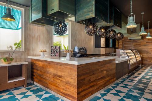 a kitchen with wooden cabinets and a counter top at Dreams Cap Cana Resort & Spa - All Inclusive in Punta Cana