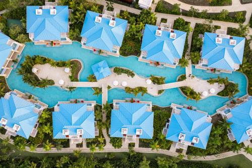 an aerial view of a resort with blue roofs at Dreams Cap Cana Resort & Spa - All Inclusive in Punta Cana
