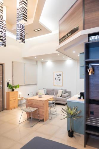a living room with a table and chairs at Evis Cosmos 1 - Meno Homes 10 in Xanthi