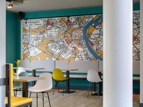 a map mural in a restaurant with tables and chairs at ibis Köln Frechen in Cologne