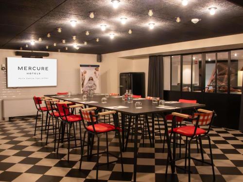 a conference room with a long table and chairs at Mercure Paris Centre Tour Eiffel in Paris