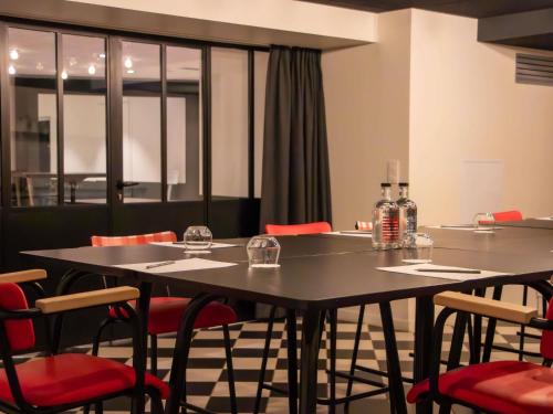 a dining room with two tables and red chairs at Mercure Paris Centre Tour Eiffel in Paris