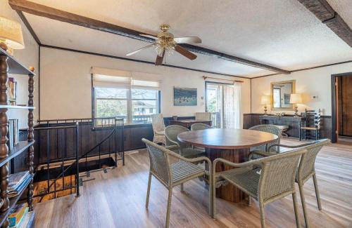 a dining room with a table and chairs at The Green House in Kitty Hawk