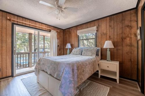 a bedroom with a bed and a ceiling fan at The Green House in Kitty Hawk