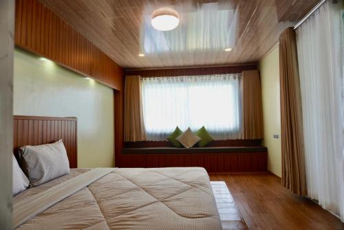 a bedroom with a large bed and a window at Kaway Resort & Spa in Tabuelan