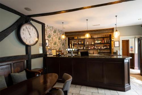 a bar with a large clock on the wall at Best Western Red Lion Hotel in Salisbury