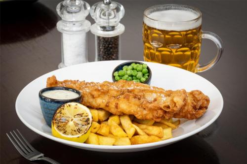 a white plate with fish and french fries and a glass of beer at Best Western Red Lion Hotel in Salisbury