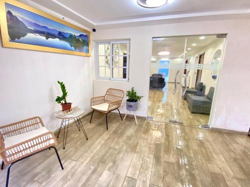 a living room with two chairs and a couch at Our Home Zudelyn H1B in Los Frailes