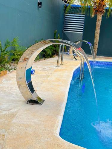 a pool with a water slide next to a house at Our Home Zudelyn H1B in Los Frailes