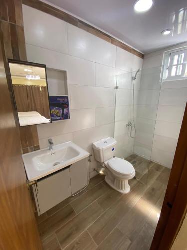 a bathroom with a toilet and a sink at Our Home Zudelyn H1B in Los Frailes
