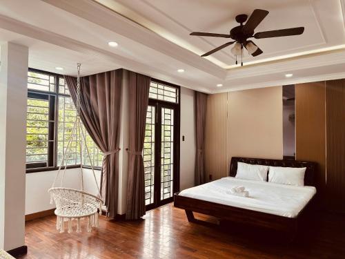 a bedroom with a bed and a ceiling fan at Kai Verde Villa in Ho Chi Minh City