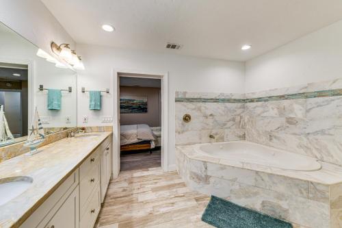 a large bathroom with a tub and a sink at Backyard with Pool and Games! Family Home in Bradenton in Palma Sola Park