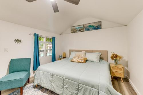 a bedroom with a bed and a blue chair at Backyard with Pool and Games! Family Home in Bradenton in Palma Sola Park