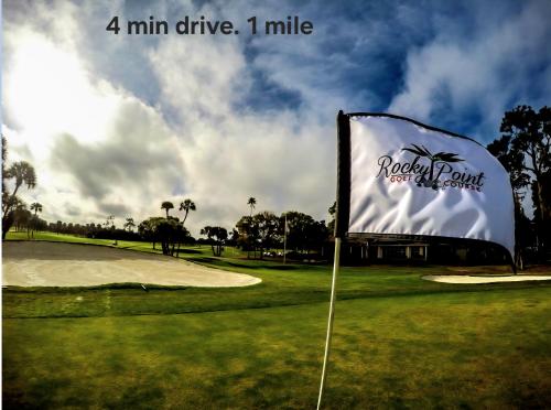 a golf course with a flag and a golf course course at The Executive Landing , 1BR, 7 TPA Airport, AC, Free Pkng, Wine, Fast Wi-Fi in Tampa