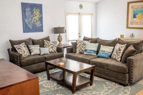 a living room with two couches and a coffee table at The Breeze in Navarre