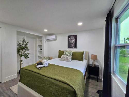 a bedroom with a bed with a teddy bear on it at The Executive Landing , 1BR, 7 TPA Airport, AC, Free Pkng, Wine, Fast Wi-Fi in Tampa
