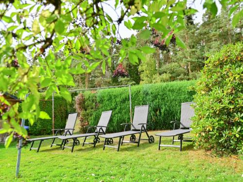 a row of benches sitting in the grass at Bärenhöhle in Marktleuthen