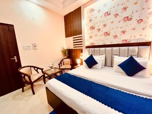 a hotel room with a bed and a chair at Hotel Rama Classic, A Four Star Luxury Hotel & Resort, Haridwar in Haridwār