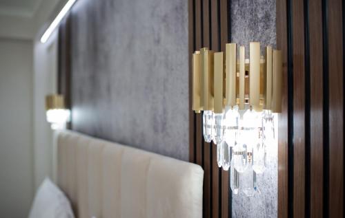 a chandelier hanging from a wall in a room at Pensiunea Paradis in Râmnicu Vâlcea